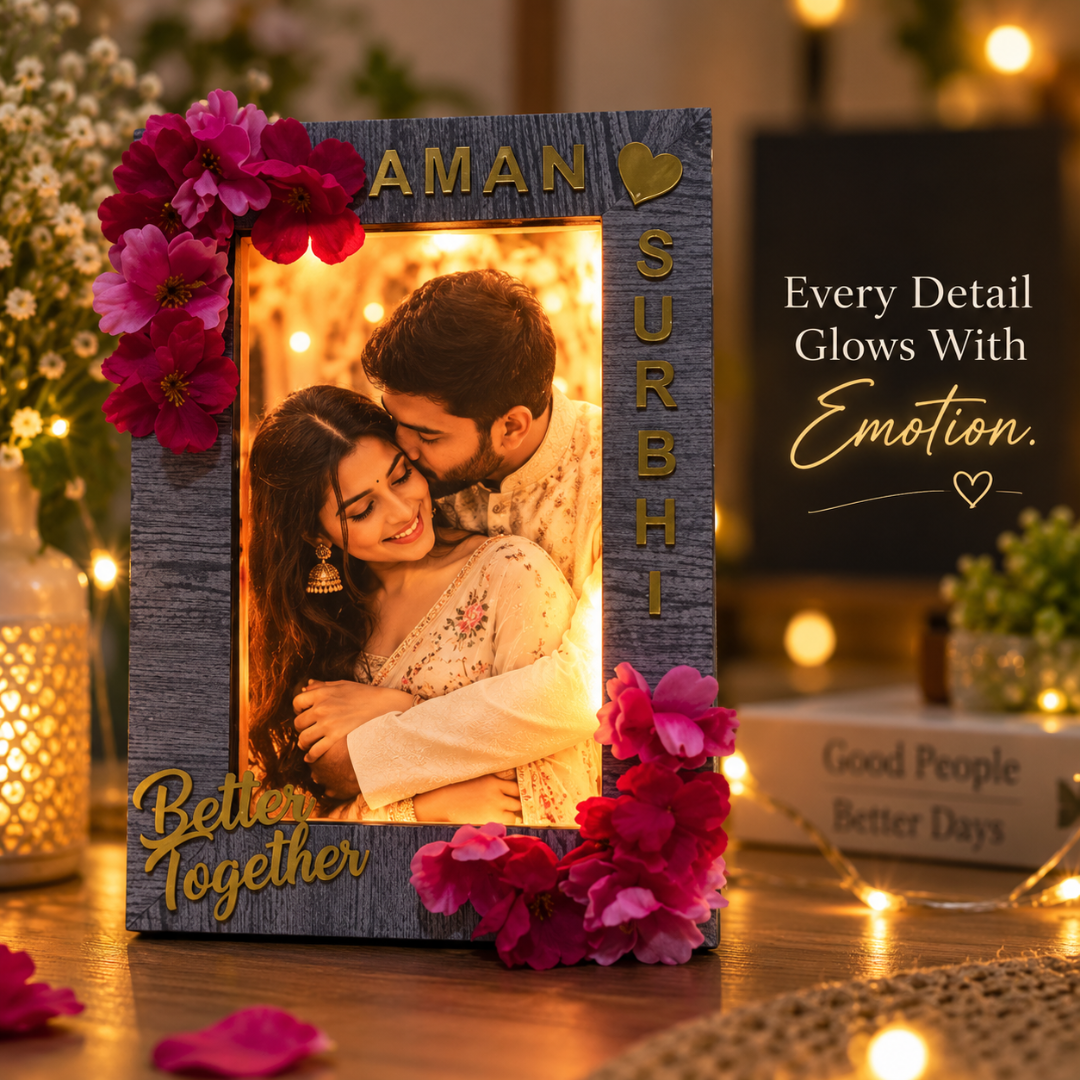 Close-up of illuminated couple photo frame with floral details